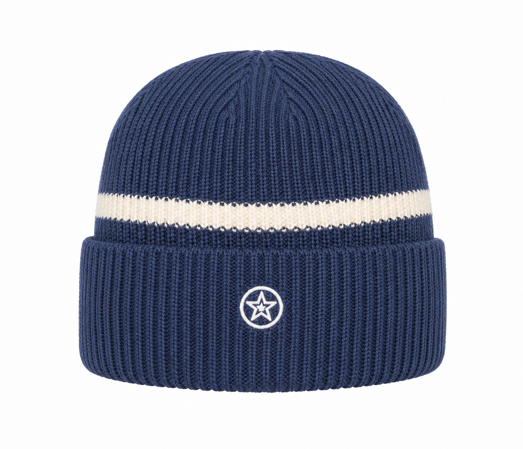A navy blue ribbed knit beanie hat with a single horizontal cream stripe across the middle and a small white circular star logo on the front cuff.